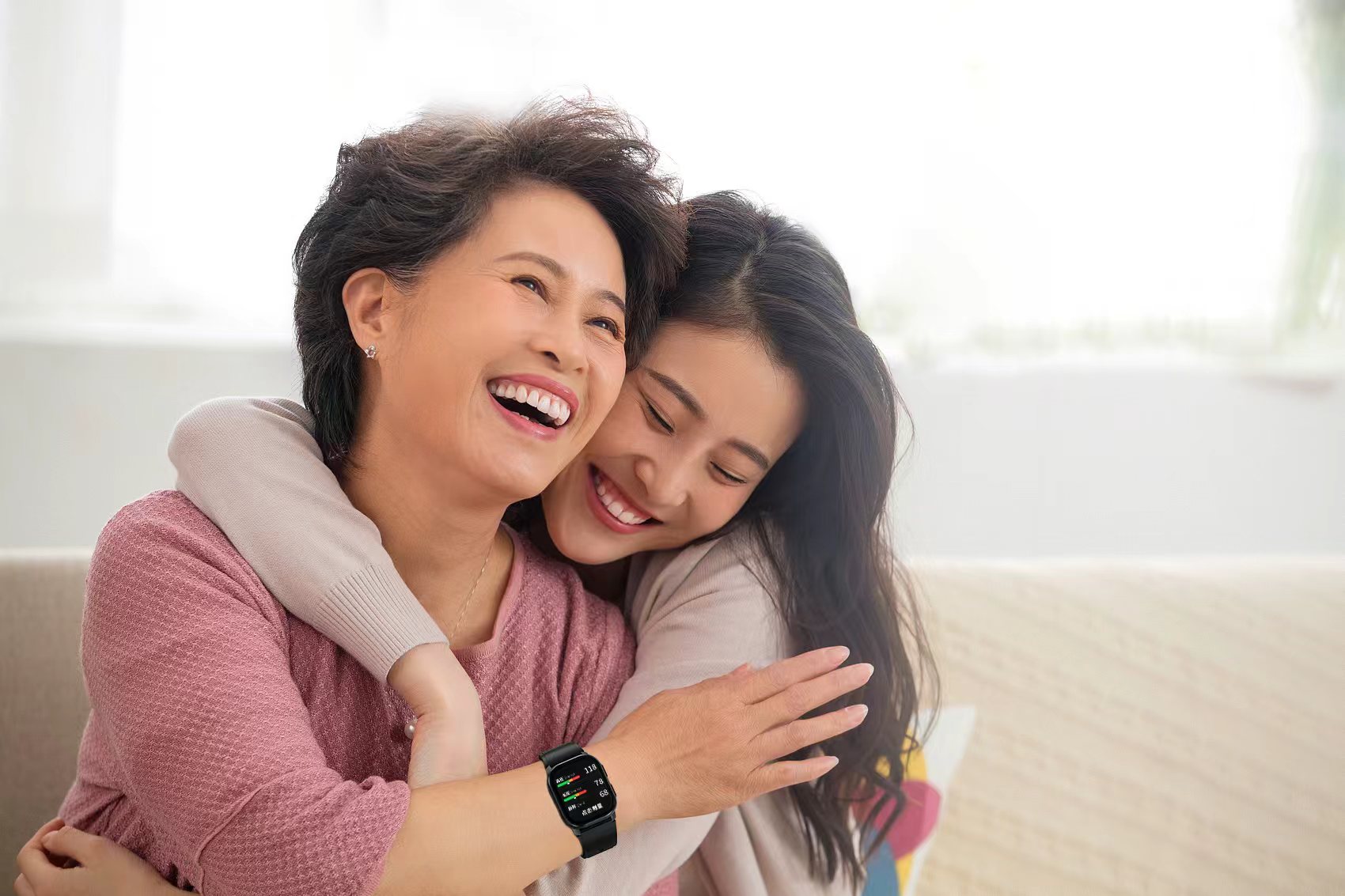 An older woman wearing a connected health watch with a family member