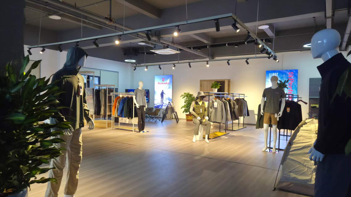 Pertemba sample room with functional apparel displayed on mannequins and garment racks