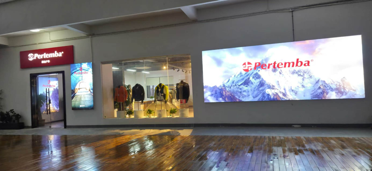 Pertemba branded display wall and window into the apparel sample area