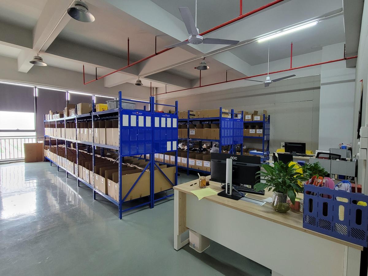 Organized material storage racks beside a factory work area