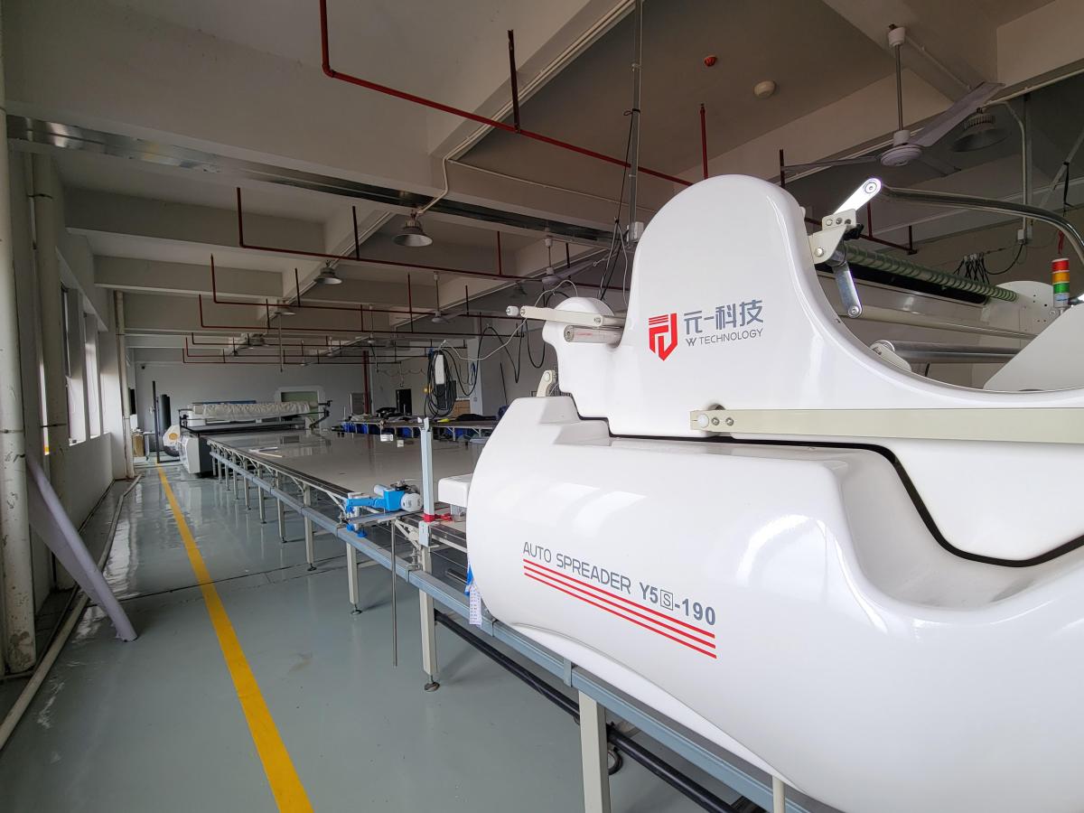 Garment cutting equipment positioned in a marked production area