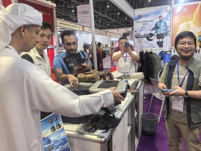 Functional product demonstration taking place with visitors at an exhibition booth