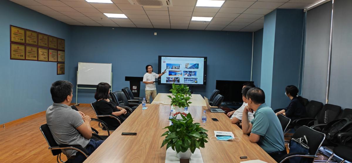Customer visitors and Pertemba staff holding a product discussion in a meeting room