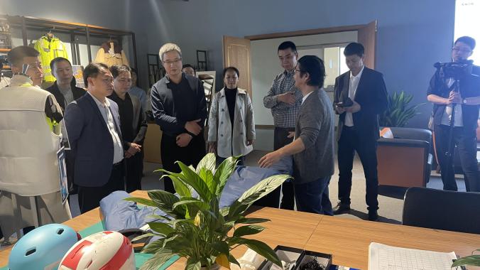 Customer visitors reviewing functional garments and samples inside the Pertemba showroom