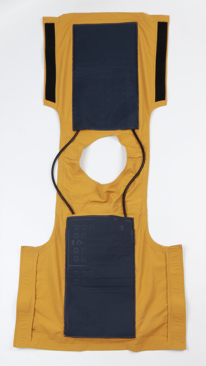 Opened yellow water-circulation cooling vest showing internal cooling panels and connecting tubes