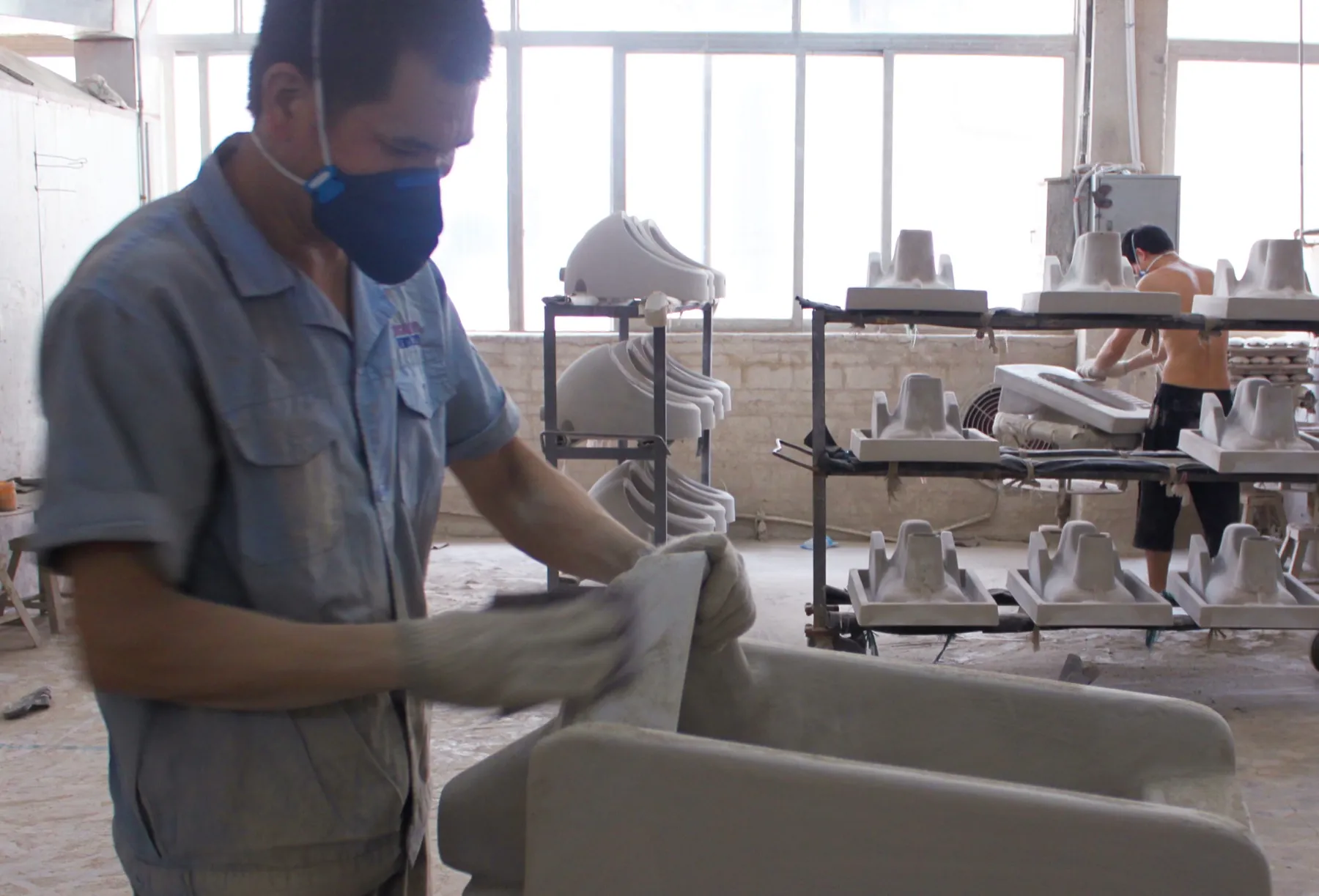 MICAWA worker inspecting and finishing ceramic sanitary ware