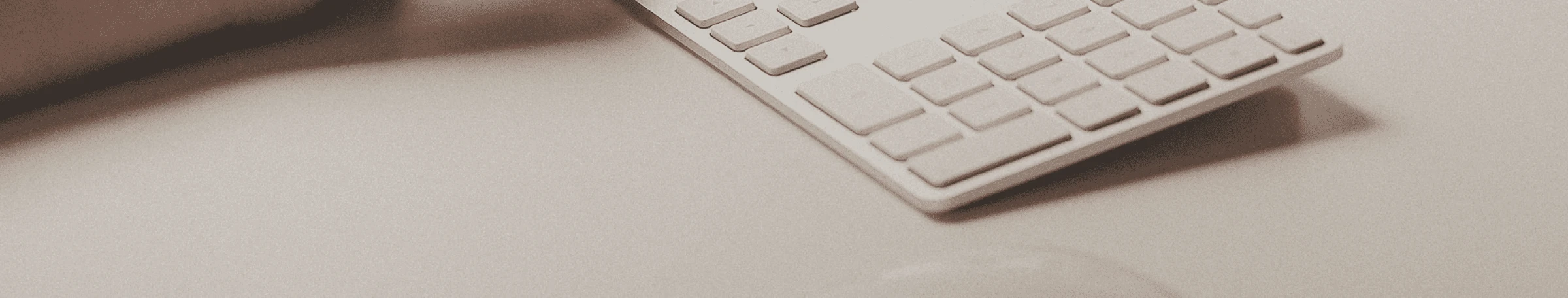 Modern office space with blue lighting, dark atmosphere, computer workstations with monitors, and glass walls