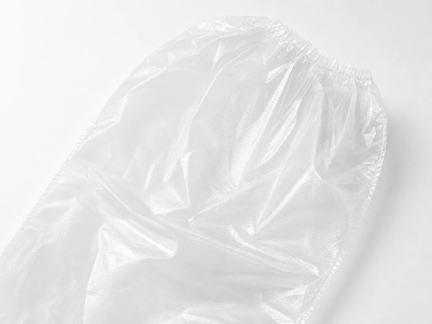 Close detail of clear PE long glove film, sealed edge and gathered elastic upper opening thumbnail