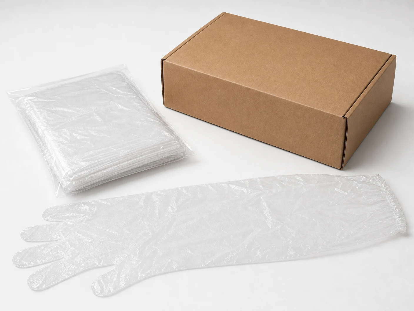 Clear PE long gloves folded in an unbranded inner bag beside a plain kraft carton thumbnail
