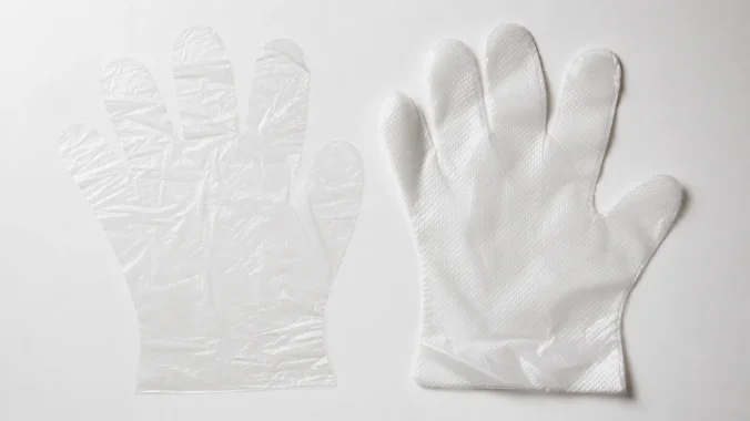 CPE disposable glove compared with a basic HDPE polyethylene glove showing thickness and clarity difference