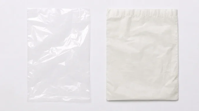 A thin clear polyethylene bag and a matte compostable bag placed side by side for comparison