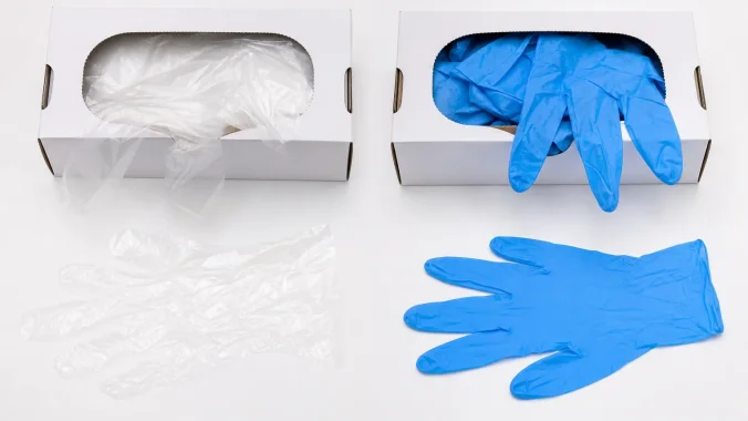 PE film gloves and nitrile gloves placed side by side showing material and format differences