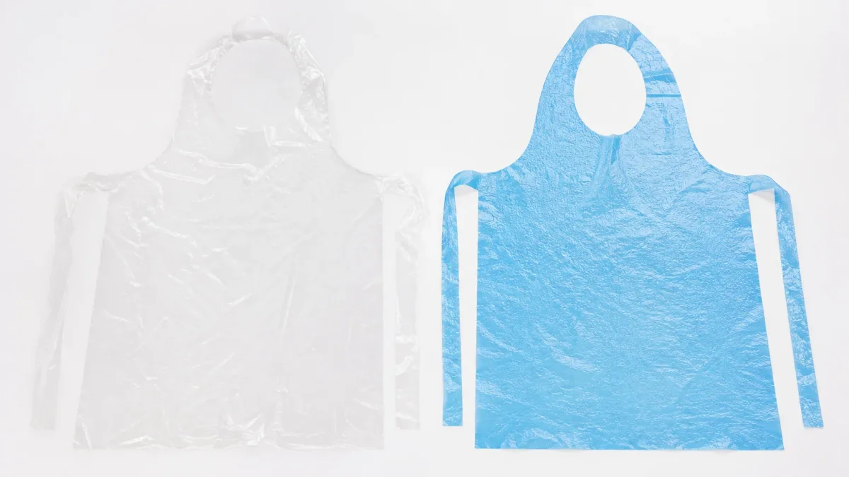 A flat thin clear PE apron compared beside a thicker embossed blue CPE apron on a white surface