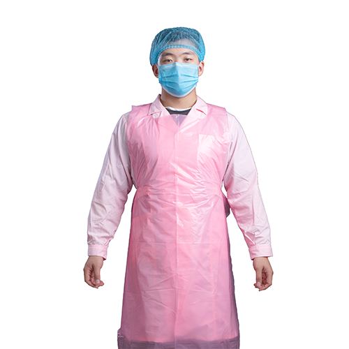 Pink disposable PE apron worn over factory workwear