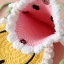 A round smiling face cross-body bag