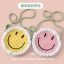 A round smiling face cross-body bag