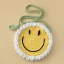 A round smiling face cross-body bag